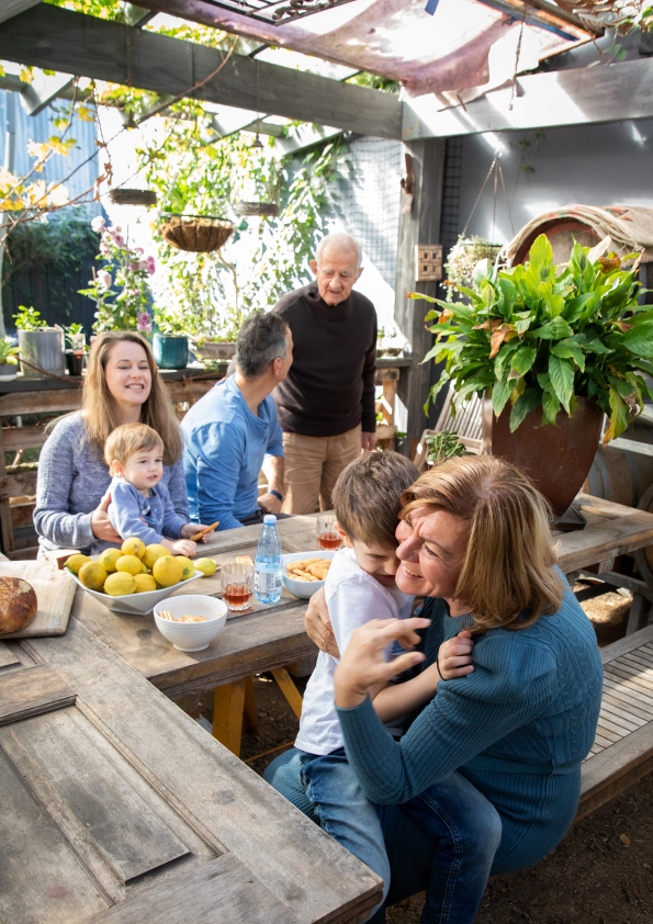 Family hanging out at a table outdoors